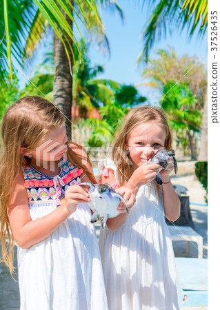 Adorable little girls with small turtles in hands Adorable little girls with small turtles in hands 37526435