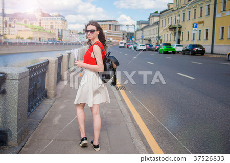 Young happy girl standing on the street in big Young happy girl standing on the street in big 37526833