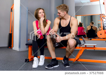 Sports girl and sports young man in the gym Sports girl and sports young man in the gym 37527088