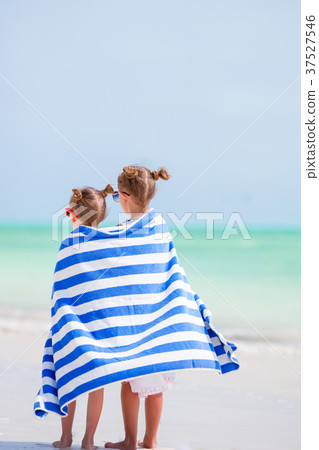 Adorable little girls wrapped in towel at tropical 37527546