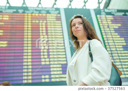 Young woman in international airport looking at 37527563