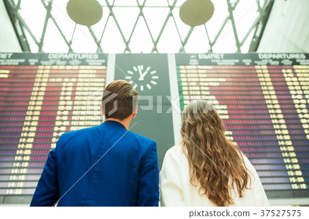Young man and woman in international airport Young man and woman in international airport 37527575