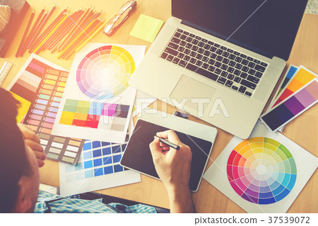 Graphic designer drawing on graphics tablet 37539072