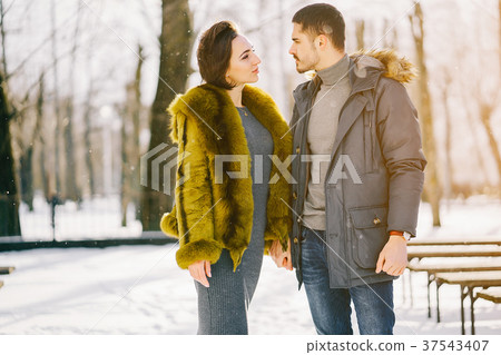happy couple walking through the park on a sunny happy couple walking through the park on a sunny 37543407