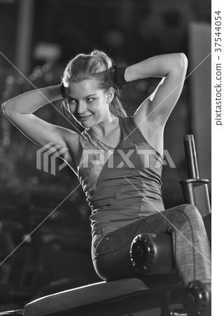 Woman doing strength exercises for abs muscles Woman doing strength exercises for abs muscles 37544054