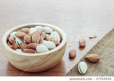 Almonds on wooden floor. Almonds on wooden floor. 37544056