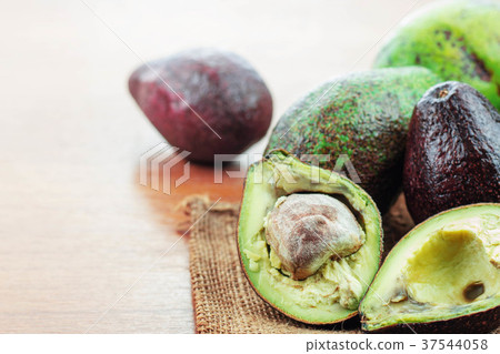 Avocado on wooden floor. Avocado on wooden floor. 37544058