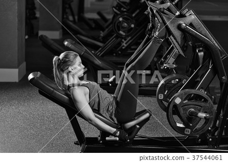 Sportive woman using weights press machine for Sportive woman using weights press machine for 37544061