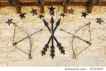 stone wall with arrows and a bow 37544497
