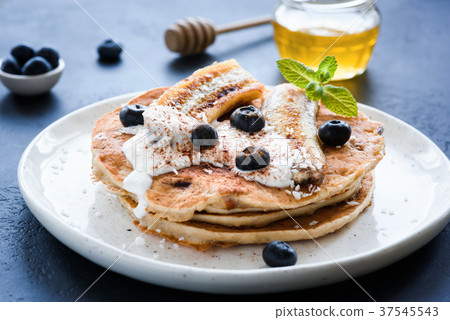 Healthy oat pancakes with banana, blueberries and 37545543
