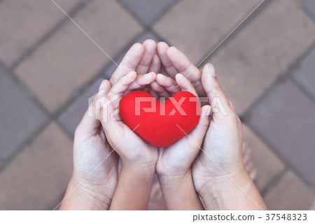 Red heart in child and mother hands with love 37548323