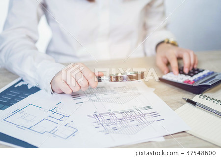 Businesswoman looking through a magnifying Businesswoman looking through a magnifying 37548600