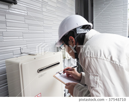 Worker checking the water heater 37548710