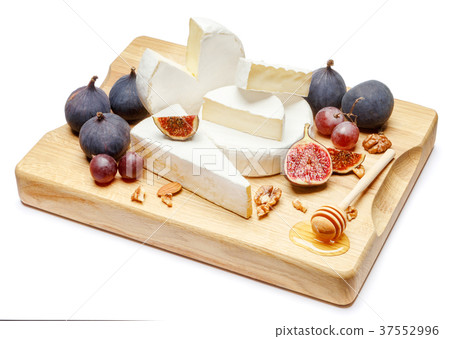 pile of brie or camambert cheese on white 37552996