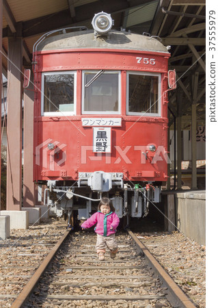 Girl walking in front of a train Girl walking in front of a train 37555979