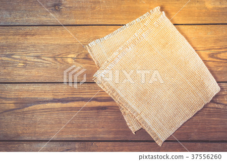 Linen napkin on vintage wooden kitchen table Linen napkin on vintage wooden kitchen table 37556260