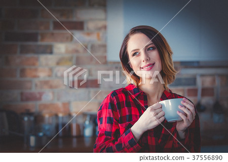 woman with cup of coffee or tea at kitchen 37556890