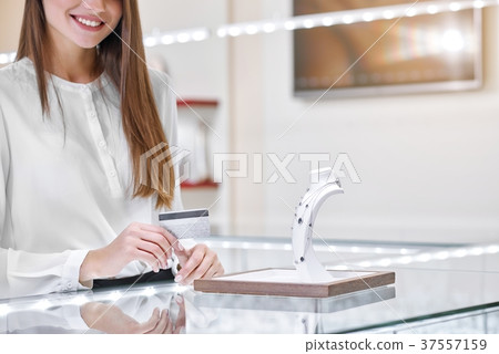 Smiling woman near the counter in a jewelry shop 37557159