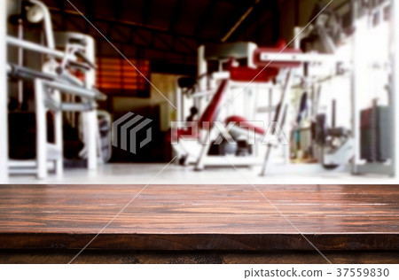 Wooden table on blurred background of fitness gym interior of mo 37559830