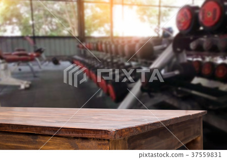 Wooden table on blurred background of fitness gym interior of mo 37559831