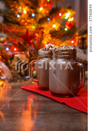 Two glasses of cocoa with whipped cream and Two glasses of cocoa with whipped cream and 37560644