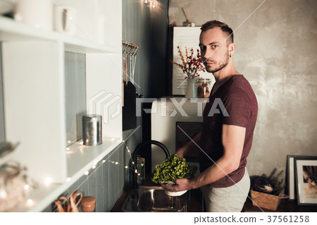Man in the kitchen. Cooking time. Rustic color 37561258