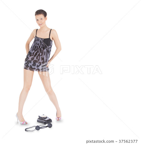 girl in dress standing over the vintage phone 37562377