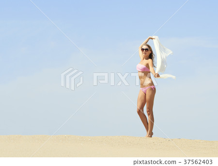 Tanned young female relaxing on the beach Tanned young female relaxing on the beach 37562403