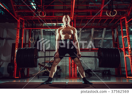 Muscular fitness man doing deadlift a barbell in 37562569