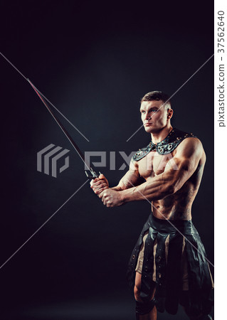 Severe barbarian in leather costume with sword 37562640