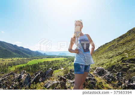 Woman taking selfie on mobile phone Woman taking selfie on mobile phone 37563394