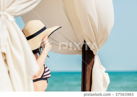 Woman looking from beach to the sea 37563983