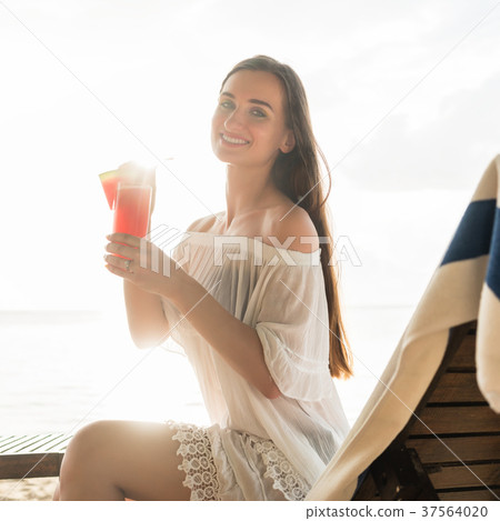 Portrait of a beautiful young woman smiling while Portrait of a beautiful young woman smiling while 37564020