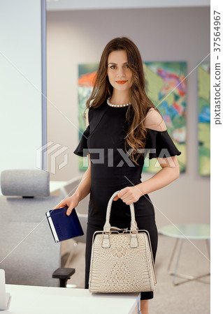 businesswoman is standing with a bag in his hand 37564967
