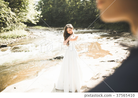 Elegant gentle stylish groom and bride near river 37565410
