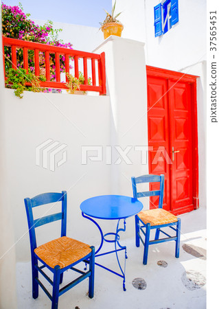 Outdoor cafe with blue chairs on street of typical 37565451