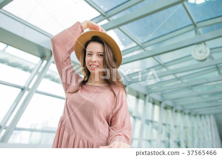 Portrait of young woman an airport lounge waiting Portrait of young woman an airport lounge waiting 37565466