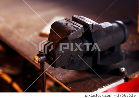 Blacksmith tools. Old vise in a forge shop Blacksmith tools. Old vise in a forge shop 37565529