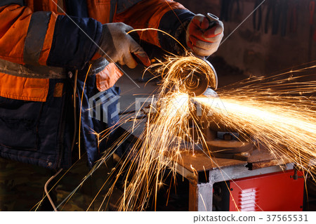 Cutting metal with angle grinder. Cutting metal with angle grinder. 37565531