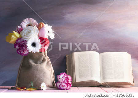 Diverse flower bouquet and an old open book Diverse flower bouquet and an old open book 37566333