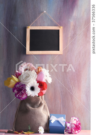 Flower bouquet with gifts and blackboard Flower bouquet with gifts and blackboard 37566336
