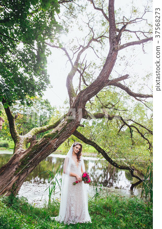 Sensual and elegant bride in the park Sensual and elegant bride in the park 37568273