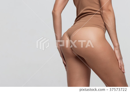Female butt, white background. Beautiful female Female butt, white background. Beautiful female 37573722