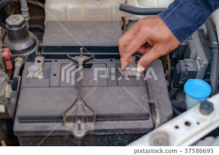Hand checking and repairing car battery Hand checking and repairing car battery 37586695