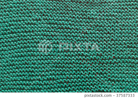 A close-up of a green knitted sweater. A close-up of a green knitted sweater. 37587333