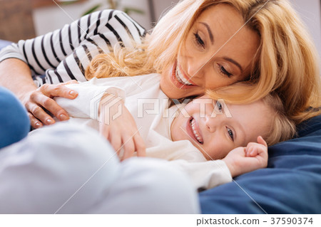 Inspired mother lying with her daughter Inspired mother lying with her daughter 37590374