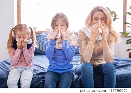 Sick mother and her daughters having a cold 37590671