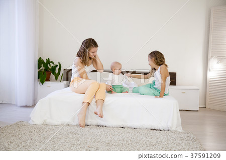three girls play sisters in the morning on the bed three girls play sisters in the morning on the bed 37591209