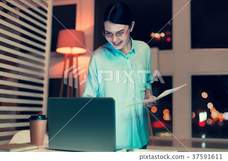 Charming woman checking information stated on 37591611