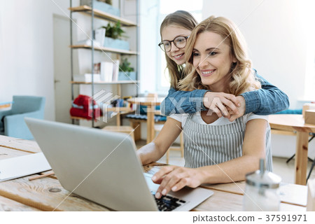 Positive delighted females looking at computer 37591971